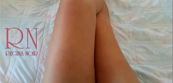  White socks. Cute chick lies on the bed, smiles, gracefully bends.